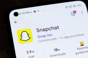 Smartphone displaying Snapchat app page, showcasing features of Snapchat AI Tools for advertising